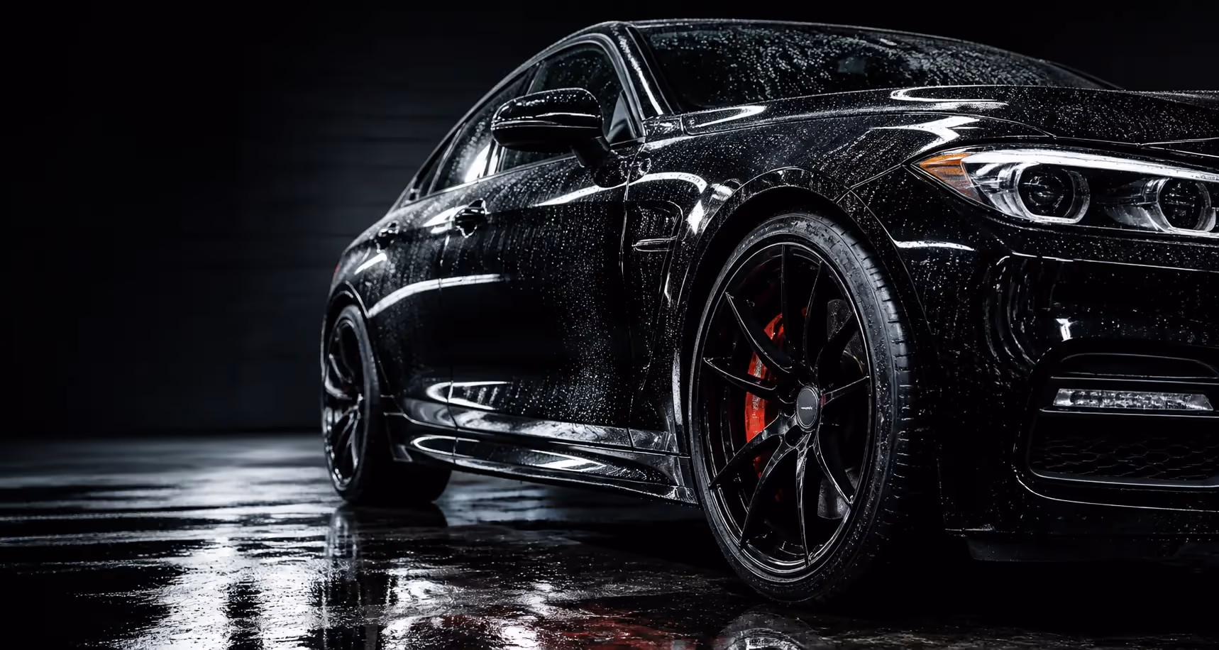 Freshly detailed black vehicle with water beads